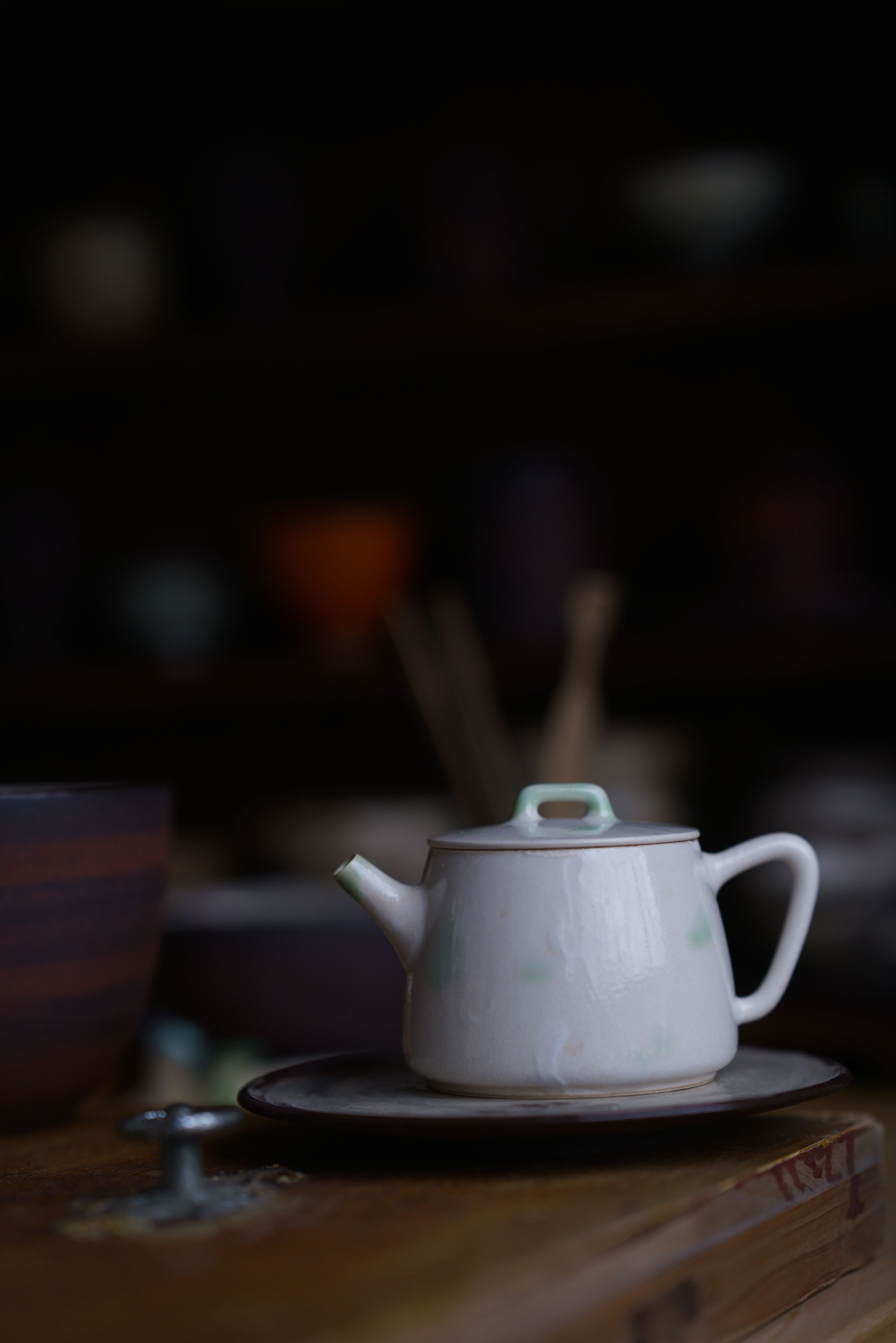 Applying ash glaze to a mug